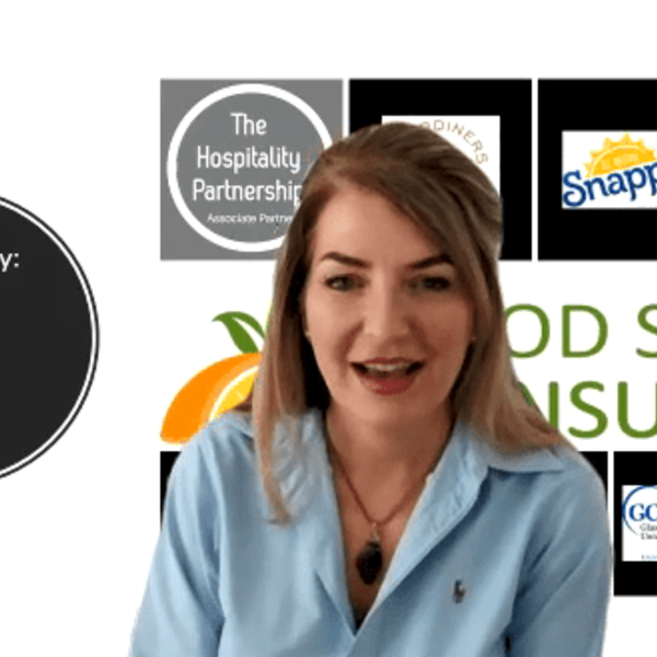 Woman speaking with multiple logos behind her.