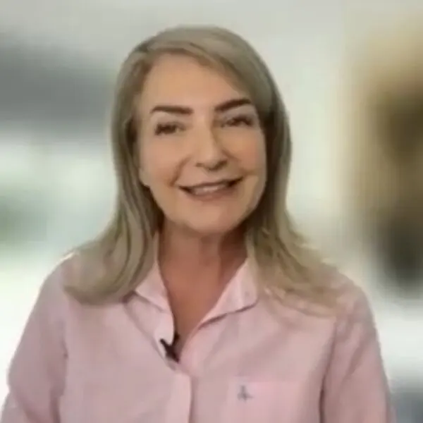 Smiling woman in a pink shirt.