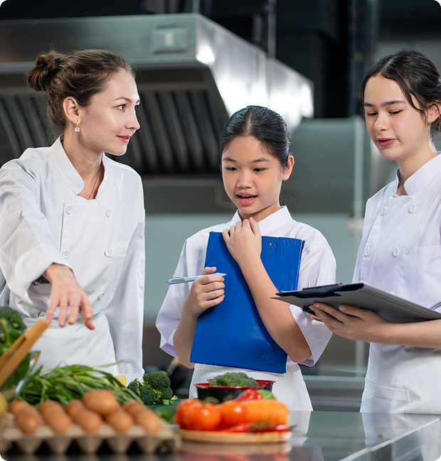 Chefs discussing ingredients in a kitchen.