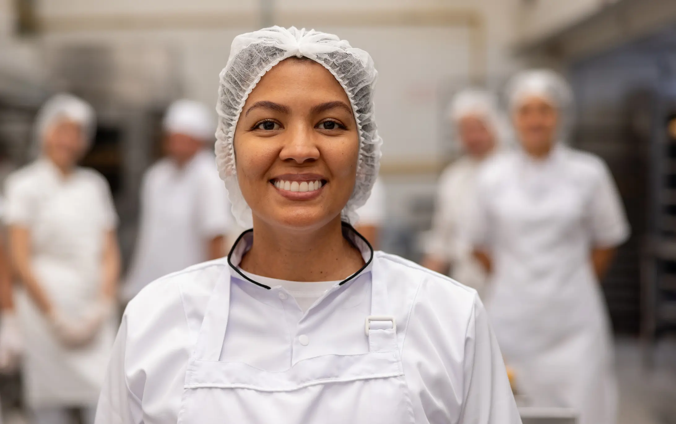 Smiling chef in a professional kitchen.