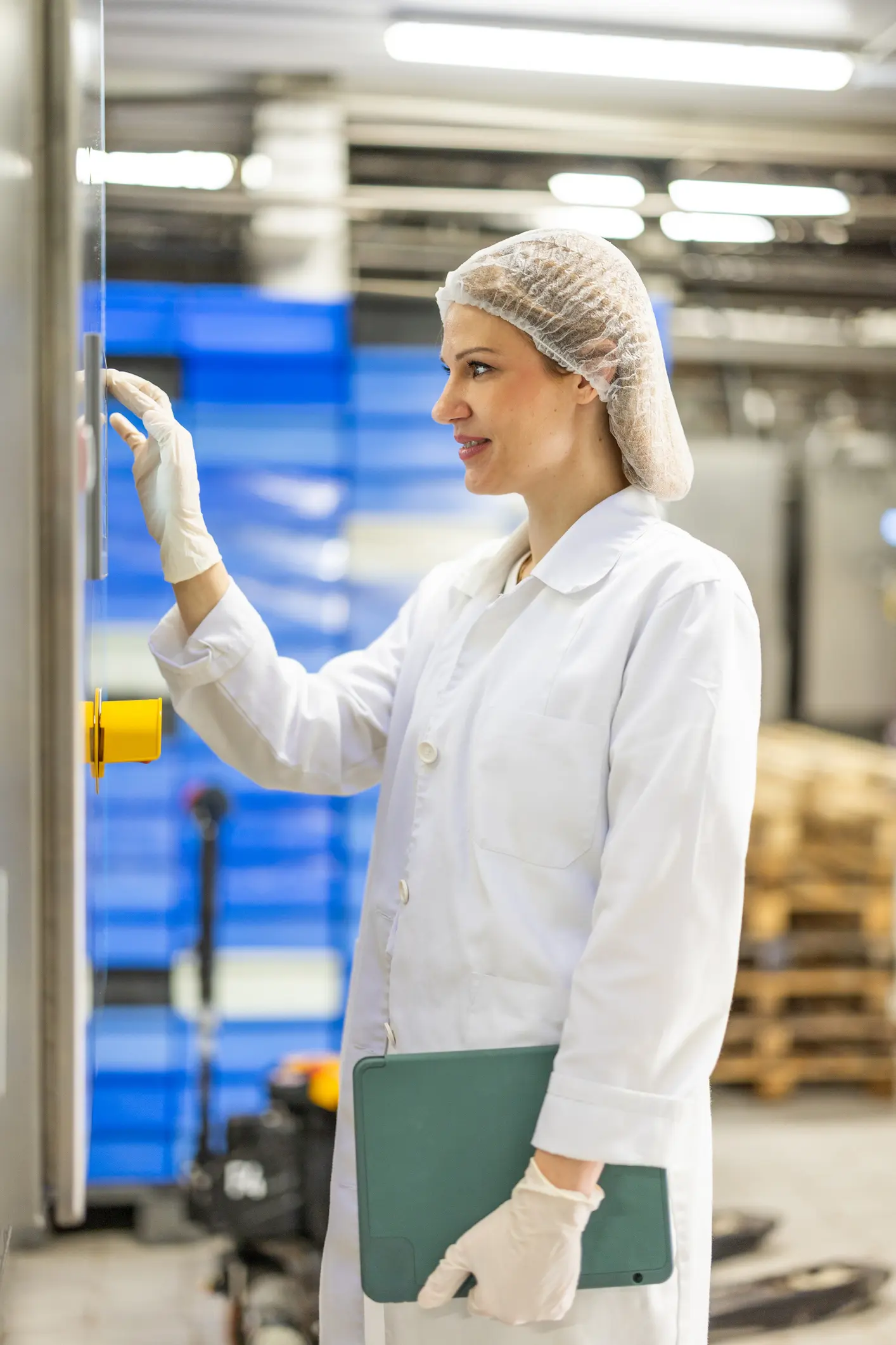 Woman in lab coat using equipment.