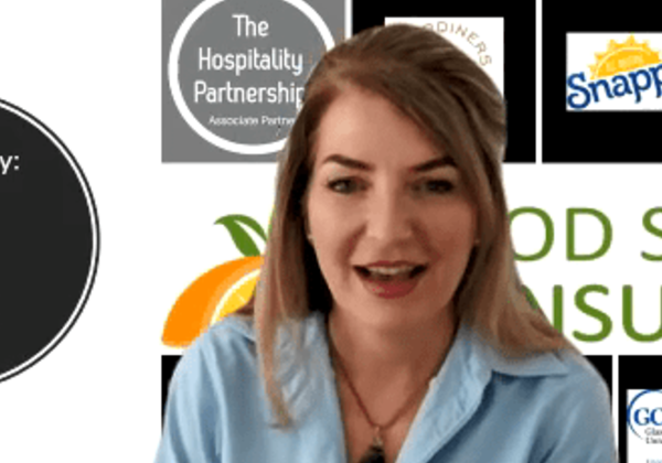 Woman speaking with multiple logos behind her.