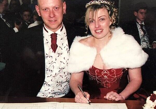 Couple signing marriage certificate at wedding.