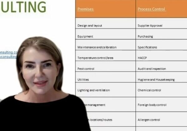 Woman presenting HACCP prerequisite program table.