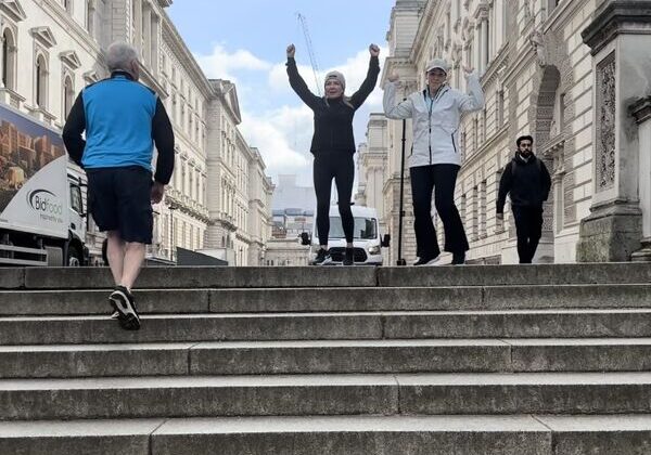 People celebrating on outdoor stone steps.