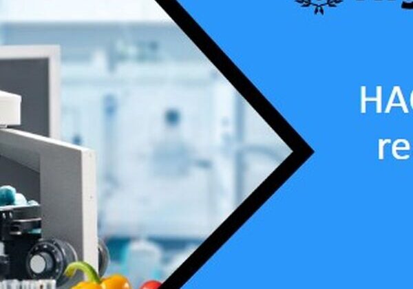 Microscope and fruits in a laboratory setting.